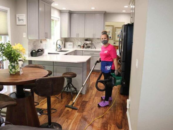 employee vacuuming the kitchen